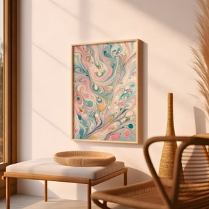 May include: A framed abstract print with swirling patterns in shades of pink, blue, green, and yellow. The print is hanging on a white wall in a modern living room setting.