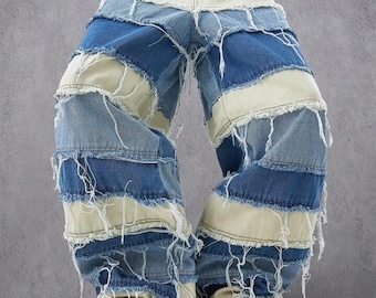 May include: Patchwork denim jeans in shades of blue and cream with frayed edges. The jeans have a high waist and are secured with a black belt with a silver buckle. White platform shoes complete the look.