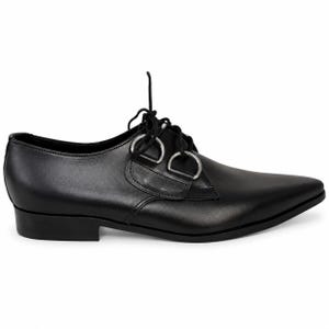 May include: Black leather dress shoe with a pointed toe and silver metal ring details. The shoe has a low heel and lace-up closure. A stylish and unique footwear option.