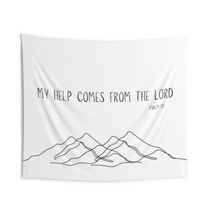 May include: White tapestry with black text that reads "My help comes from the Lord, Psalm 121". The text is above a black line drawing of mountains.