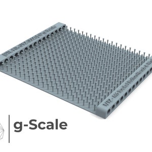 May include: A gray plastic tool with a grid of small metal pins. The tool is labeled "1/2 - M3 Socket Dimensions & Kinematic".
