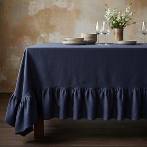 May include: A white ceramic mug with a black handle and the text "But First, Coffee" in a bold, black font. The mug is set against a blurred background, suggesting a cozy setting. The mug appears to be approximately 4 inches tall.