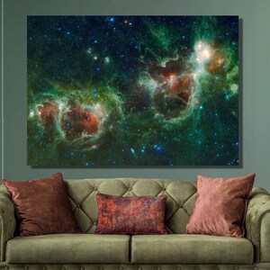 May include: A green and red nebula with stars in a dark blue space. The nebula is a cloud of gas and dust that is lit up by nearby stars.