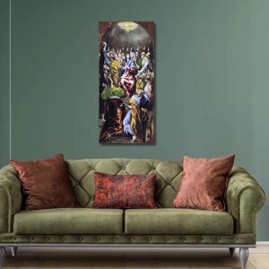 May include: A vertical framed painting depicting a religious scene with figures in various colors. The artwork hangs above a green sofa with brown pillows. The room has a green wall and a black shelf with decorative items.