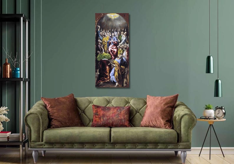 May include: A vertical framed painting depicting a religious scene with figures in various colors. The artwork hangs above a green sofa with brown pillows. The room has a green wall and a black shelf with decorative items.