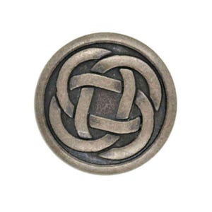 May include: A round, silver-toned button with a Celtic knot design. The knot is in a dark grey colour and is raised from the surface of the button.