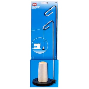 May include: A sewing thread spool holder with a black base and a tall, silver metal frame. The holder is designed to hold a spool of thread, with a guide at the top to feed the thread. The packaging is blue.
