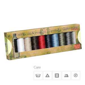 May include: A box of Gütermann creativ rPET-100% recycled polyester thread spools in various colours, including white, beige, brown, red, dark blue, light blue, green, and grey. The box has a green and brown design with the text "rPET-100% recycled Polyester" and "Gütermann creativ" printed on it. The box also has a "Value Pack!" sticker on it.