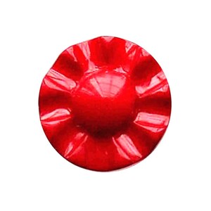 May include: A bright red, circular object with a textured, ridged surface. The centre of the object is smooth and glossy, reflecting light. The shape is reminiscent of a stylized flower or button.