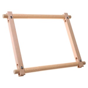 May include: A light-coloured wooden embroidery hoop with adjustable tension. The frame is rectangular, with rounded dowels at each corner. The text "CLEESE'S EASYCLIP" and "TURN TO TENSION" are printed on the wooden bars.