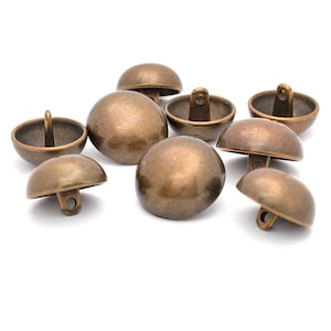 May include: A group of eight antique gold dome-shaped buttons with a shank on the back.