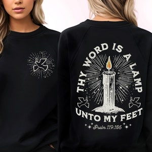 May include: Black sweatshirt with a white dove graphic on the front and a white graphic on the back that says "Thy Word Is A Lamp Unto My Feet Psalm 119:105".