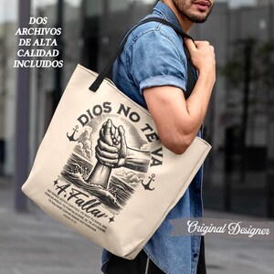 May include: Beige tote bag with black handles featuring a graphic of two hands clasped together, with the words "DIOS NO TE VA A FALLAR" and other text in Spanish. The bag also has two anchors and the text "DOS ARCHIVOS DE ALTA CALIDAD INCLUIDOS".