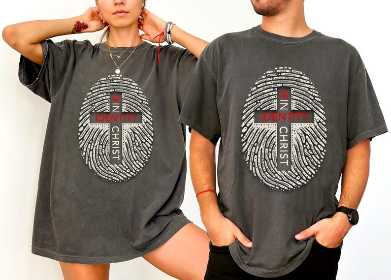 May include: Two gray t-shirts with a fingerprint design and the text "In Identity In Christ" printed on the front.
