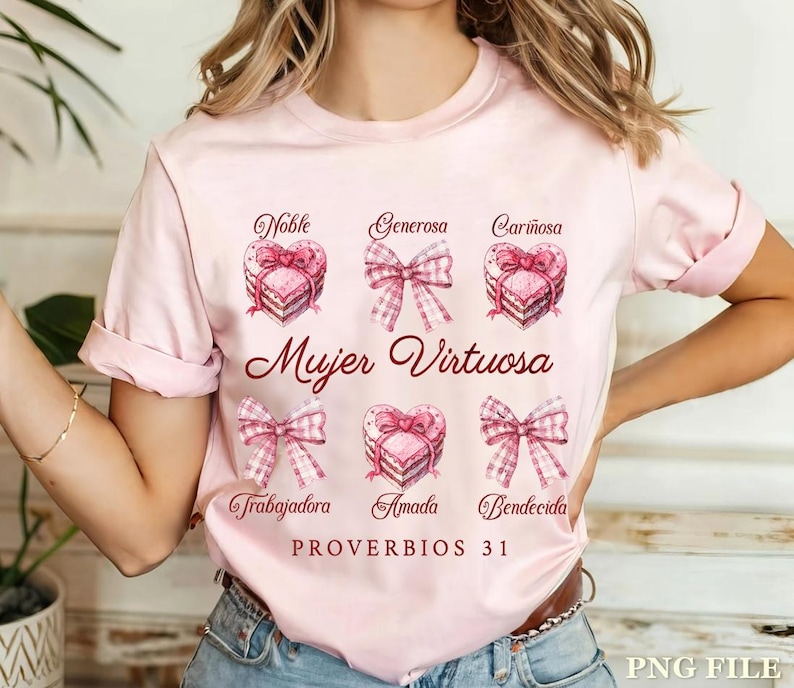 May include: Pink t-shirt with a watercolor design of hearts and bows. The text "Mujer Virtuosa" is written in red. The words "Noble, Generosa, Cari&ntilde;osa, Trabajadora, Amada, Bendicida" are written around the hearts. The text "Proverbios 31" is written at the bottom of the design.