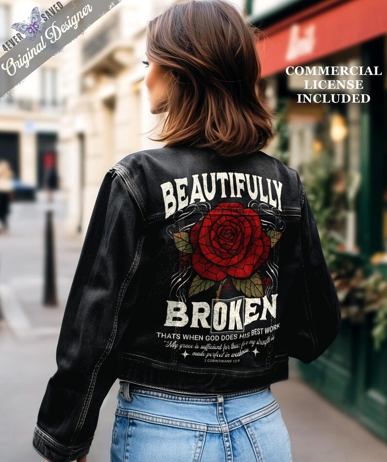 May include: Black denim jacket with a large red rose graphic and the words "BEAUTIFULLY BROKEN" on the back. The jacket also features text that reads "THAT'S WHEN GOD DOES HIS BEST WORK" and "My grace is sufficient for thee: for my strength is made perfect in weakness."
