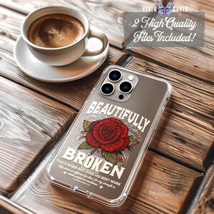 May include: A clear phone case with the words "BEAUTIFULLY BROKEN" and a red rose design. The case also includes the text "THATS WHEN GOD DOES HIS BEST WORK" and "1 CORINTHIANS 12:9". A cup of coffee sits in the background.