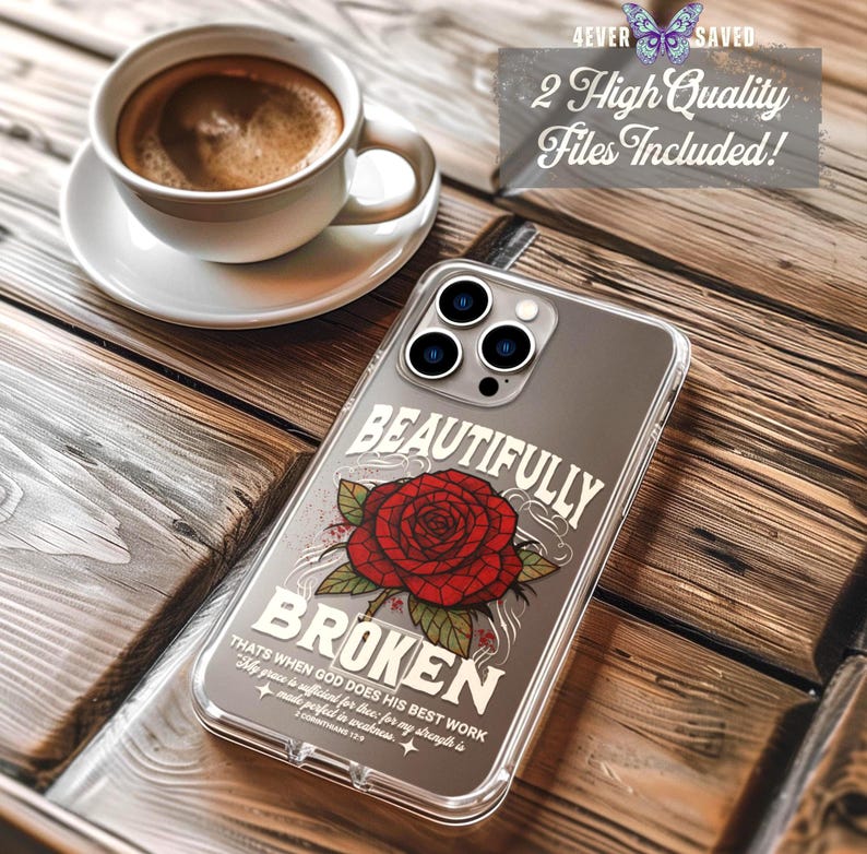 May include: A clear phone case with the words "BEAUTIFULLY BROKEN" and a red rose design. The case also includes the text "THATS WHEN GOD DOES HIS BEST WORK" and "1 CORINTHIANS 12:9". A cup of coffee sits in the background.