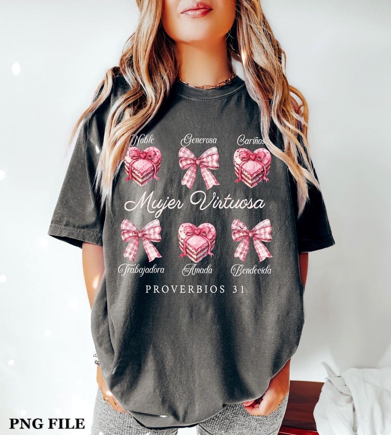 May include: A gray t-shirt with a pink and white design featuring a heart with a bow and the text "Mujer Virtuosa" and "PROVERBIOS 31".