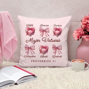 May include: Pink throw pillow with the text "Mujer Virtuosa" and "PROVERBIOS 31" in brown lettering. The pillow features a series of pink hearts with brown cake designs and pink bows with white polka dots.