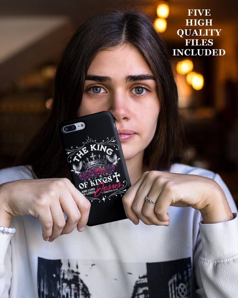 May include: A black phone case with a white design that says "The King of Kings and Lord of Lords Jesus" with a crown and cross. The text "1 Timothy 6:15" is also included.
