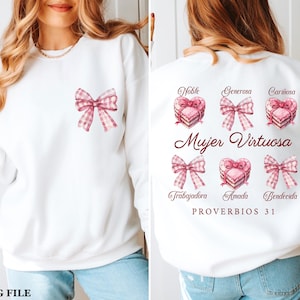 May include: White sweatshirt with a pink and white bow on the front and a pink and white heart design on the back. The back design includes the text "Mujer Virtuosa" and "PROVERBIOS 31".