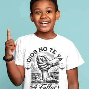 May include: White t-shirt with a graphic design featuring the text "DIOS NO TE VA A Fallar" and a hand reaching out of the water. The design includes anchors and the Bible verse Isaiah 41:10. The shirt is worn by a young person.