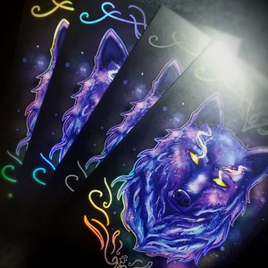 May include: Three black cards with a holographic wolf design. The wolf is purple and blue with a galaxy pattern. The cards have rainbow holographic accents.