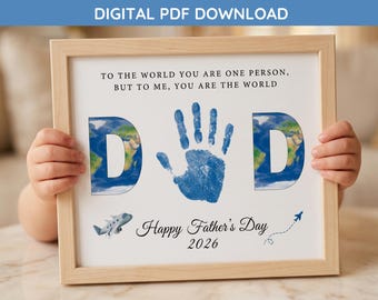 May include: A framed print with the word "DAD" in blue, featuring a handprint and world map imagery. The print includes the text "Happy Father's Day 2026" and a quote. A small airplane graphic is also included.