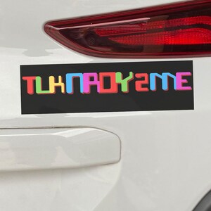 Pode incluir: Um carro branco com um adesivo preto no pára-choques que diz "THINPADKY2ME" em letras coloridas.