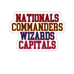 May include: A sticker displaying the names of Washington D.C. sports teams: Nationals, Commanders, Wizards, and Capitals. The text is in a bold, blocky font with red, blue, and gold colours, outlined in white.