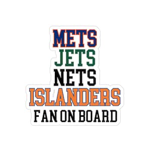 May include: A die-cut sticker featuring the text METS in blue and orange, JETS in green, NETS in black, and ISLANDERS in orange and blue, followed by the black text FAN ON BOARD. The design uses bold, block-style lettering on a white background.