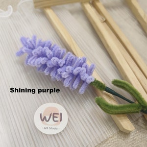 May include: A purple and green flower made of pipe cleaners, with the text "Shining purple" and a logo that says "WEI - Art Studio -" on a white background.