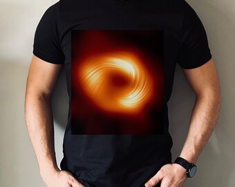 May include: A black t-shirt with a graphic of a bright orange and yellow ring, resembling a black hole, on the front.