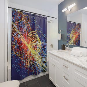 May include: A shower curtain with an abstract design. It features a central burst of yellow and red lines against a deep blue background. The pattern includes smaller blue and red shapes, creating a dynamic, scientific-themed aesthetic.