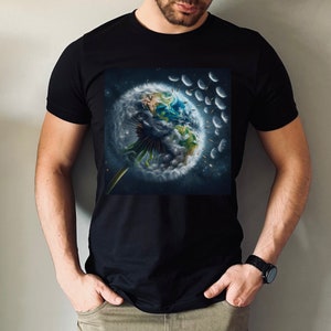 May include: A black t-shirt featuring a graphic of the Earth inside a dandelion. The dandelion seeds are blowing away in the wind.