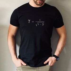 May include: A black t-shirt with the equation for time dilation from Einstein's theory of special relativity:  γ = 1 / √(1 - v²/c²)
