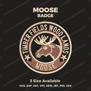 May include: A brown embroidered patch with a moose head in the center. The patch is circular and has the text "Timber Fields Wood Lands" around the edge. The text "Moose" is also embroidered below the moose head.