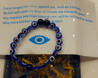 May include: A blue and black evil eye bracelet with a white background. The bracelet is surrounded by yellow and black confetti. The text on the white background reads: "Every tongue that rises against me, shall be silenced: No Evil will come my way, or invade my energetic space; Any negative intention towards me, will be returned to sender; May every Evil Eye upon me be BLIND!"