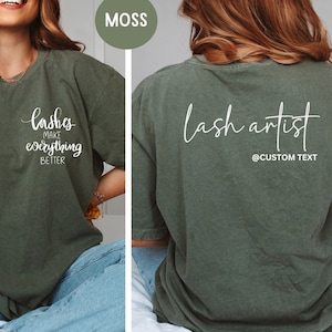 May include: Moss green t-shirt with white text. The front of the shirt says "lashes make everything BETTER". The back of the shirt says "lash artist" with "@CUSTOM TEXT" below. The shirt is a comfortable, casual style.