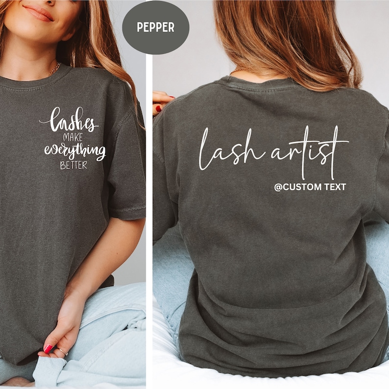 May include: Pepper-colored t-shirt with white text. The front of the shirt says "lashes make everything better". The back of the shirt says "lash artist" with "@CUSTOM TEXT" below. The shirt is a comfortable, casual style.