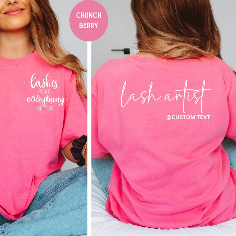 May include: A bright pink t-shirt with white text on the front that reads "lashes make everything better." The back of the shirt says "lash artist" with a space for custom text. The shirt is a loose fit.