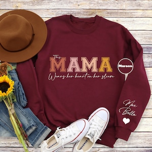 Custom This Mama Wears Her Heart On Her Sleeve Sweatshirt, Personalized Mom Hoodie With Kids Names, Cute Momma Outfits, Mothers Day Gifts