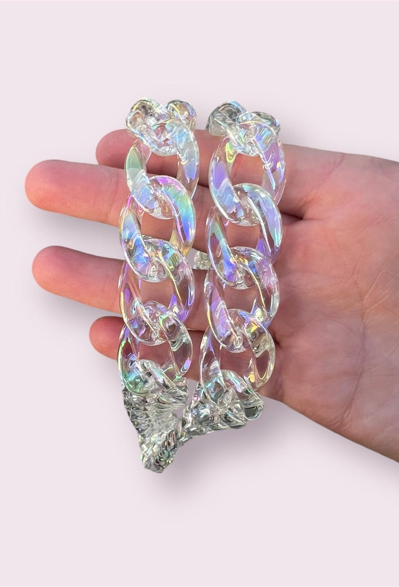 May include: A clear iridescent plastic chain necklace with large links.