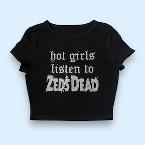 May include: Black crop top with the text "hot girls listen to ZEDS DEAD" in white rhinestones.