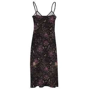 May include: A black slip dress with a floral design of purple roses, birds, and butterflies. The dress has thin straps and a V-neck. The fabric is decorated with small, gold-coloured dots.