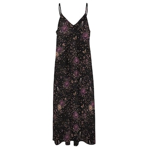 May include: A black maxi dress with spaghetti straps and a V-neck. The dress is patterned with purple roses, birds, and butterflies. The fabric looks lightweight, ideal for summer wear. The dress is long.