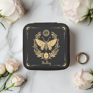 May include: Black jewelry box with a gold butterfly design, floral accents, and the name "Shelley" inscribed on the front.