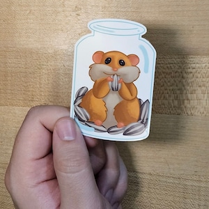 Adesivo de vinil fofo de girassol comendo hamster em jarra