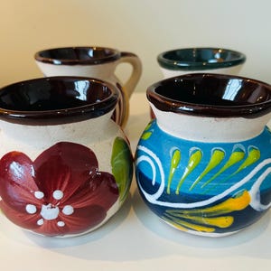 Set of 4, handmade and hand painted pottery “tequila” jugs/mugs from Mexico.
